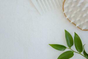 Comb and scalp massager on a white towel. Hair care concept. photo