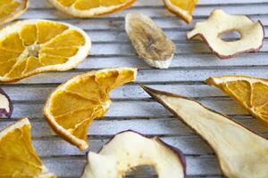 Dried fruits on a gray background, close up. Healthy snack. Fruit chips. photo
