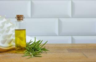 Rosemary oil on a light background. Natural hair care. photo