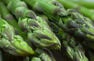 Fresh green asparagus with water drops, macro photography. photo
