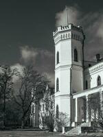 The tower of the old palace black and white concept photo. White Palace in Kharkov region, Ukraine photo