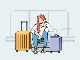 Upset woman airport passenger sits near luggage and waits for plane that is late due to bad weather vector