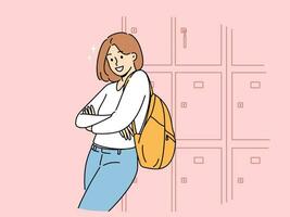 Woman student stands near boxes for personal items in college hallway and looks at screen smiling vector