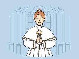 Little catholic girl takes part in first holy communion and stands in temple making prayer gesture vector