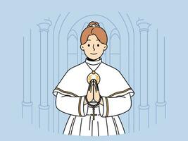 Little catholic girl takes part in first holy communion and stands in temple making prayer gesture vector