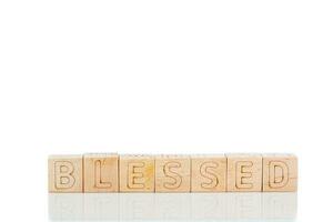 Wooden cubes with letters blessed on a white background photo