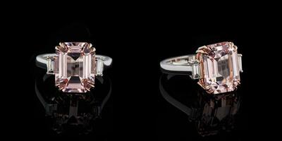 beautiful gold ring with morganite and diamond gemstones on a black background photo