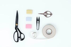 set of ruler, chalk, sticky tape, scissors for sewing on white background photo