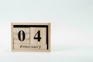 Wooden calendar February 04 on a white background photo