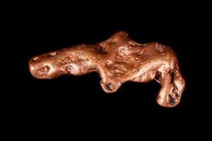 Macro mineral stone of a copper nugget on a microcline on a black background photo