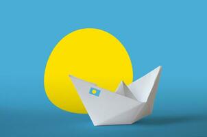 Palau flag depicted on paper origami ship closeup. Handmade arts concept photo