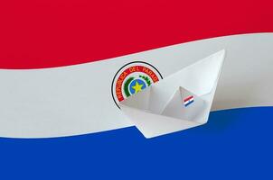 Paraguay flag depicted on paper origami ship closeup. Handmade arts concept photo