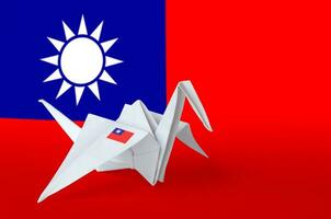 Taiwan flag depicted on paper origami crane wing. Handmade arts concept photo