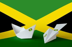 Jamaica flag depicted on paper origami airplane and boat. Handmade arts concept photo