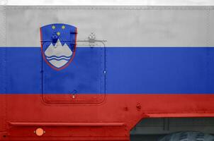 Slovenia flag depicted on side part of military armored truck closeup. Army forces conceptual background photo