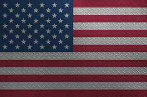 United States of America flag depicted in paint colors on old brushed metal plate or wall closeup. Textured banner on rough background photo