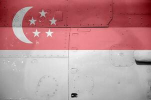 Singapore flag depicted on side part of military armored helicopter closeup. Army forces aircraft conceptual background photo