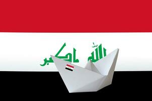 Iraq flag depicted on paper origami ship closeup. Handmade arts concept photo