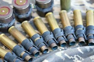 Ukrainian army fabric and machine gun belt shells lies on ukrainian pixeled military camouflage photo