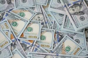 Very big amount of US hundred dollar bills. Huge quantity of united states currency notes on flat table photo