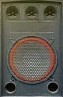 Old used audio speaker texture on dark blue photo