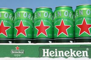 KHARKOV, UKRAINE - JULY 31, 2021 Green tin cans of Heineken lager beer produced by the Dutch brewing company Heineken N.V. photo