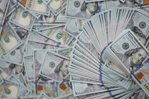 Very big amount of US hundred dollar bills. Huge quantity of united states currency notes on flat table photo