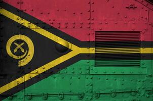 Vanuatu flag depicted on side part of military armored tank closeup. Army forces conceptual background photo