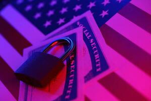 Padlock and social security card on United States flag. Identity theft and identity protection concept photo