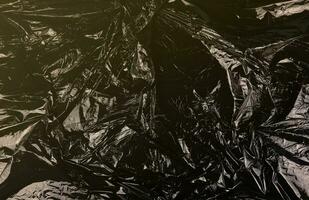 Texture of black plastic garbage disposable bag photo