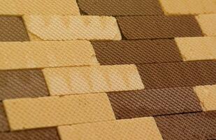 Stacked delicious chocolate wafers in large amount. Two different flavours of classic waffles photo