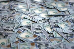 Very big amount of US hundred dollar bills. Huge quantity of united states currency notes on flat table photo