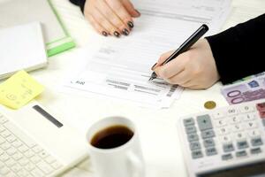Accountant fill german tax form Einkommensteuererklarung in end of tax period. Taxation and paperwork routine photo