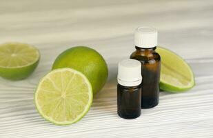 Oil essence bottle with citrus extracts. Selective focus. Spa day, concept of freshness oil bottle with lime photo