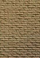 Texture of brick wall from relief stones under bright sunlight photo