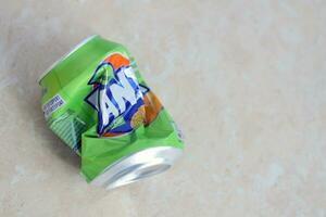 KYIV, UKRAINE - 4 MAY, 2023 Fanta soft drink brand crumpled tin can with exotic flavour photo