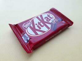 KHARKIV, UKRAINE - JANUARY 2, 2021 Kit Kat by Nestle chocolate covered wafer on bright color photo