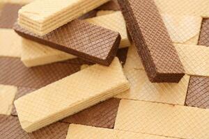 Stacked delicious chocolate wafers in large amount. Two different flavours of classic waffles photo