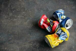 KYIV, UKRAINE - 4 MAY, 2023 Fanta soft drink brand crumpled tin cans with various flavours photo