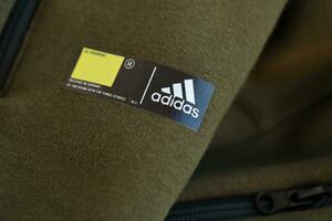 KYIV, UKRAINE - 4 MAY, 2023 Adidas company logo on new brand clothes photo