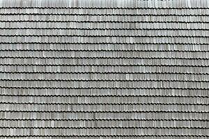 gris de madera techo losas antecedentes textura. un cerca arriba de antiguo gris techo cubierto con de madera losas foto