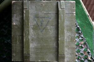 Soviet army ammunition stack of green crates with russian names of ammo type and category photo
