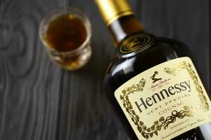 KYIV, UKRAINE - MAY 4, 2022 Hennessy Very Special original alcohol bottle on black wooden table photo