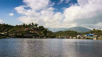 village on mountain reflection on water against sky video