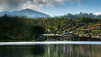 village on mountain reflection on water against sky video