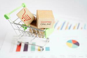 Online shopping, Shopping cart box on business graph, import export, finance commerce. photo