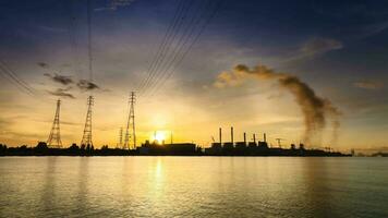 Power plant beside river under colorful sky at sunrise time video