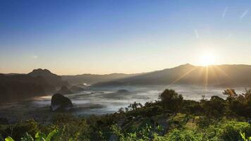 cloudy foggy landscape view above of mountain at sunrise timing video