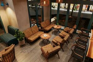 The interior of a cozy modern restaurant with chairs, coffee table with coffee, and botany. photo