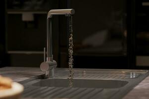 Water falls into the sink, 3d rendering of kitchen. photo